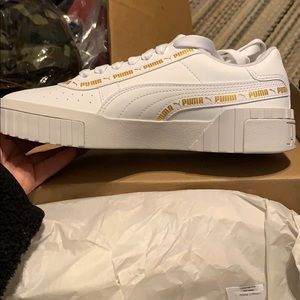 pink pumas with gold writing